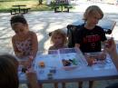 Griffin, Eve, and Celeste try out some hands-on STEM activities at the ATARA trailer. [ATARA photo.]